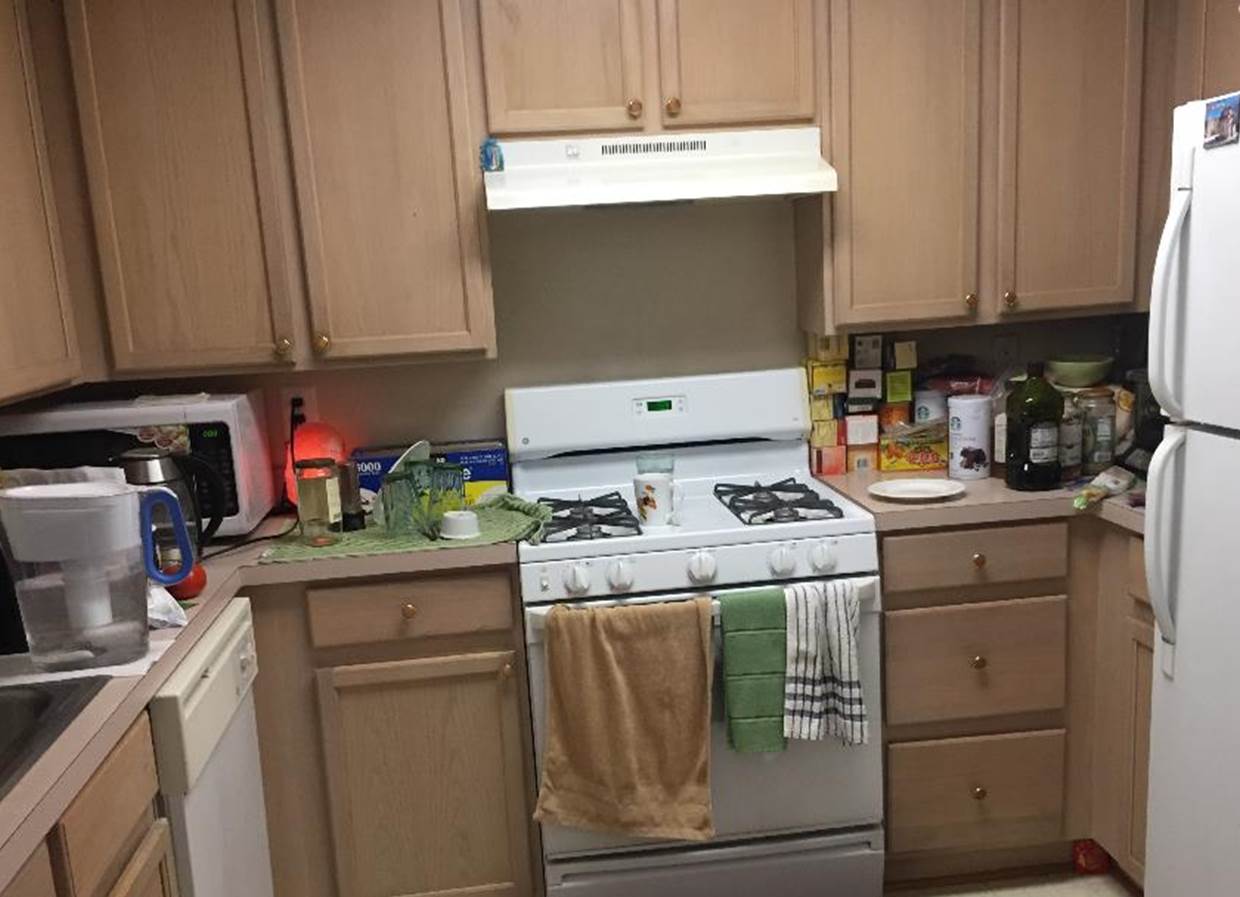 A kitchen with wooden cabinets

Description automatically generated with medium confidence